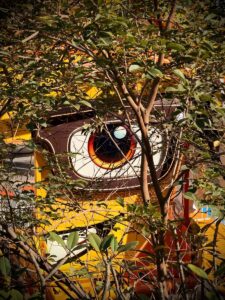 A large, cartoonish eye on a yellow building