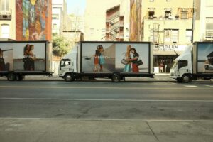 A line of delivery trucks parked on the side of the road
