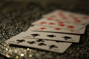 Playing cards fanned out on a sparkling, textured surface.