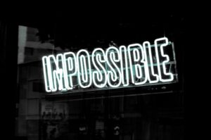 a neon sign that reads impossible visible in a window
