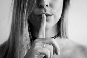 a woman making a hush with her finger