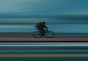 a blurry photo of a person riding a bike